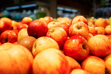 Many bright juicy red apples on the counter. Healthy eating and vegetarianism.