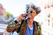 © MandriaPix - Afro-American man on a phone call, portrait of trendy Hispanic boy, fashionable black guy with yellow sunglasses, urban lifestyle