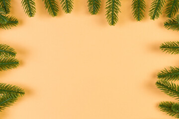 Top view of colorful festive background made of fir tree branch. Christmas holiday concept with copy space