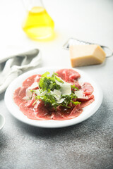 Poster - Traditional beef carpaccio with parmesan cheese and arugula