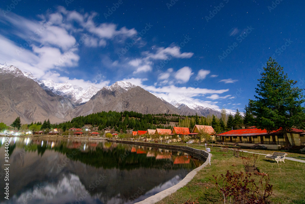 lake with red top huts and still water with reflection, lower kachura ...