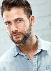 Poster - Portrait of young handsome man against white brickwall. 