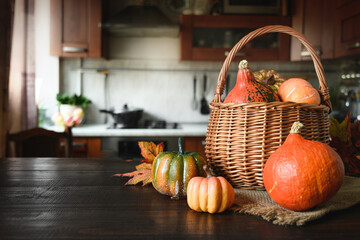 Domestic Halloween party with pumpkins on tabletop and blurred kitchen as backdrop. Home celebrations during a pandemic.