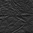© artistmef - Black vintage and old looking crumpled paper background. Retro cardboard texture. Grunge paper for drawing. Ancient book page. Present wrapping.