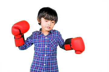 Cute little boy wears red boxing gloves on studio