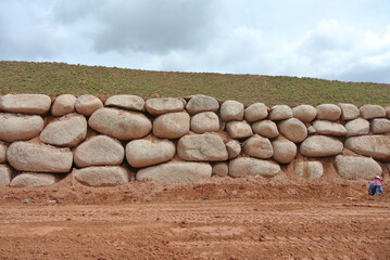 Wall Mural - Stone boulders are stacked on the ground and used as retaining walls. It acts to resist soil erosion caused by rain.