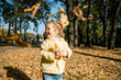 © gesrey - Little girl walks in the park in autumn and throws leaves