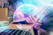 © peshkova - Technology theme hologram over woman's hands taking notes background. Concept of Tech. Double exposure