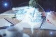 © peshkova - Multi exposure of writing hand on background with brain hologram. Concept of self learning.
