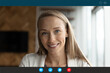 © fizkes - Close up screen view portrait of smiling young Caucasian woman look at camera speak talk on video call. Happy millennial female involved in virtual digital conference, have online web meeting.