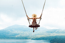 Beautiful Girl Enjoying Freedom On Swing In Bali, Indonesia