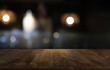© Charlie's - Empty dark wooden table in front of abstract blurred bokeh background of restaurant . can be used for display or montage your products.Mock up for space.