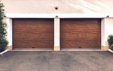 Modern double car garage doors. Large automatic up and over garage doors. Close- up photo.