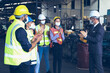 © torsakh - Leader or manager meeting with engineer and technician or operator while line walk in factory workplace, team working at maintenance machine shop, face mask covid-19 protection