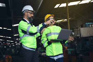 Wall Mural - Engineer team inspect or checking the machine in workshop factory, the technician control for repair or maintenance part or equipment by radio and computer 