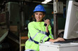 © torsakh - Lady engineer or worker is working in factory with using computer and radio for operate and communication