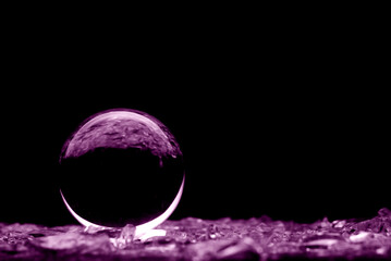 Wall Mural - Abstract glass ball in purple. A crystal ball with blurry pattern. Glass ball in blur.