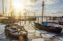 Historic Fishing Boats In The Harbor In Hamburg Övelgönne In Winter During Scenic Sunset