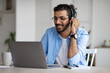 © Prostock-studio - Smiling Young Indian Guy Watching Webinar On Laptop, Wearing Headset And Eyeglasses
