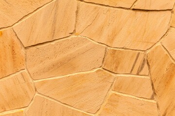 Brown stone cladding wall pattern and texture background