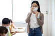 © JR-50 - An Asian female teacher was wearing a face mask while teaching students in the classroom. Group of Diversity students wear a protective face mask to prevent the spread of the Coronavirus.