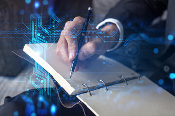 Businessman in suit taking notes. Double exposure with binary tech theme hologram. Man writing down important information in his business diary.