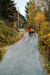 Mother, brother and sister are walking in the beautiful autumn forest. Viivis and strong colors. Shot in Gol, Hallingdal, Norway