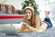 © chinnarach - close up young beautiful woman sit on sofa couch and using smartphone to searching discount promotion in cyber monday and black friday for shopping online at living room for christmas festival concept