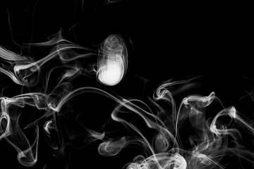 Clouds of white smoke on a black background, movement of smoke, smoke in the shape of a jellyfish