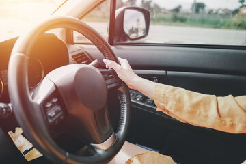 hands of car driver on steering wheel, road trip, driving on highway road