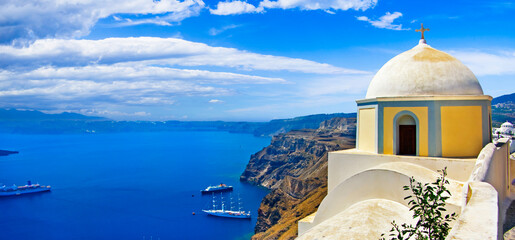 Wall Mural - Iconic Santorini - most beautiful island in Europe. view with traditional churches in Fira village. Greece