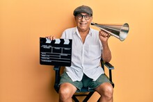 Handsome Mature Director Man Holding Video Film Clapboard And Louder Smiling And Laughing Hard Out Loud Because Funny Crazy Joke.