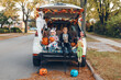 © anoushkatoronto - Trick o trunk. Siblings brother and sister celebrating Halloween in trunk of car. Children kids boy and baby girl celebrating October holiday outdoors. Social distance and safe alternative celebration