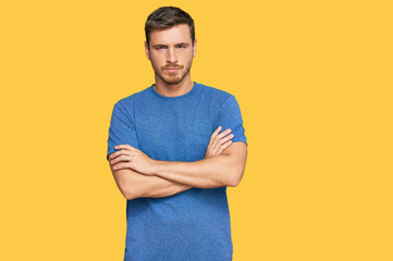 Handsome caucasian man wearing casual clothes skeptic and nervous, disapproving expression on face with crossed arms. negative person.