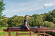 © Андрей Рыков - Ten year old caucasian girl doing front split on handrail of wooden stairs in city park on sunny summer morning. Outdoor sport theme.