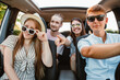 group of friends in car. road trip concept. summer vacation