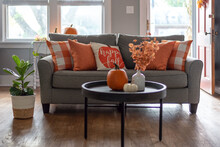 Home Interior Decorated For Fall With Orange Accent Pillows On The Couch