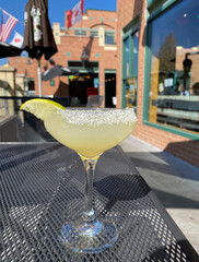 A Glass of Margarita with local restaurant in the background