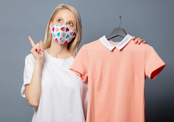 Canvas Print - Beautiful girl in face mask with pink dress on grey background