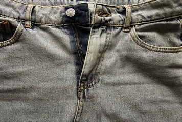 Blue jeans texture, unbuttoned jeans with pockets.