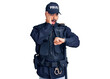 © Krakenimages.com - Young hispanic man wearing police uniform looking at the watch time worried, afraid of getting late