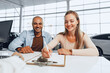 © fotofabrika - Beautiful young couple signs documents at car dealership showroom