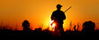 A silhouette of a male hunter carrying a shotgun. He could be hunting pheasant, chukar, partridge, grouse, dove or quail.