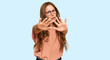 © Krakenimages.com - Young hispanic woman wearing casual clothes and glasses doing stop gesture with hands palms, angry and frustration expression