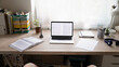 © fizkes - Working place of student with opened computer, papers and textbooks on table without people. Comfortable home office of young freelancer, remote workspace interior or distant education concept.