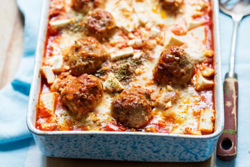 Wall Mural - Baked oregano pork meatballs in tomato sauce with mozzarella and pecorino cheese