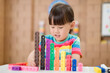 © M-image - young girl play number blocks for homeschooling