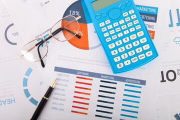 Wall Mural - Calculator and signature pen and a pair of glasses on financial documents