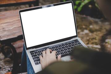 computer mockup blank screen.hand woman work using laptop with white background for advertising,contact business search information on desk at coffee shop.marketing and creative design