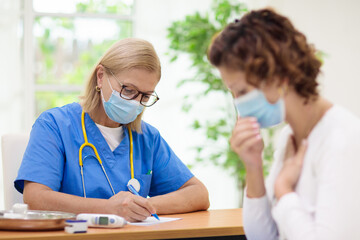 Wall Mural - Doctor examining sick patient. Ill woman in clinic